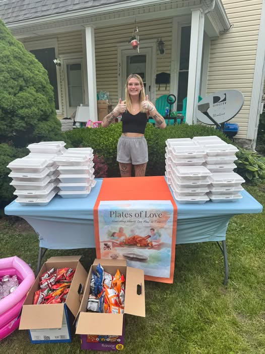 Becca serving meals outside her home